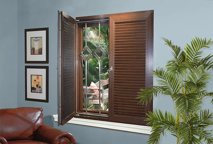 Brown wooden louvre window with steel security bars inside